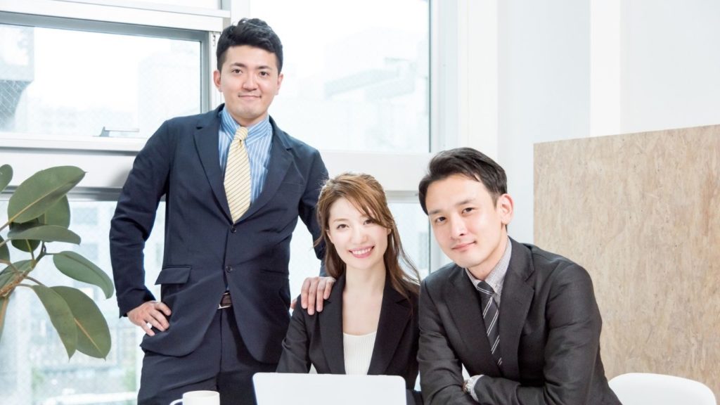 Professional business team posing together in a modern office environment