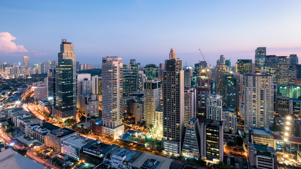 Modern city skyline with illuminated high-rise buildings at dusk